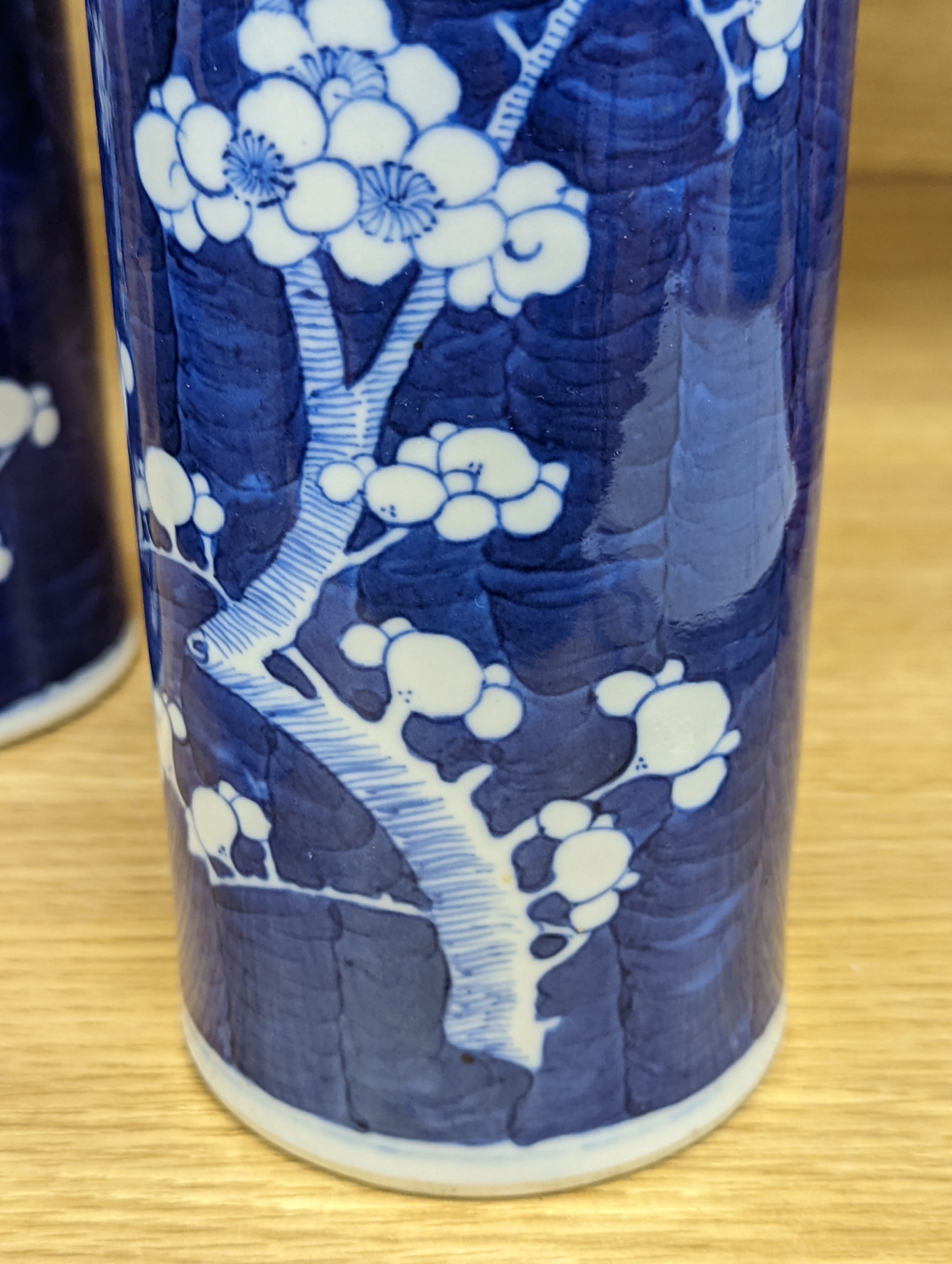 An 18th century Chinese famille rose mug, a Chinese Imari tea caddy and two Chinese blue and white sleeve vases 30cm (4)